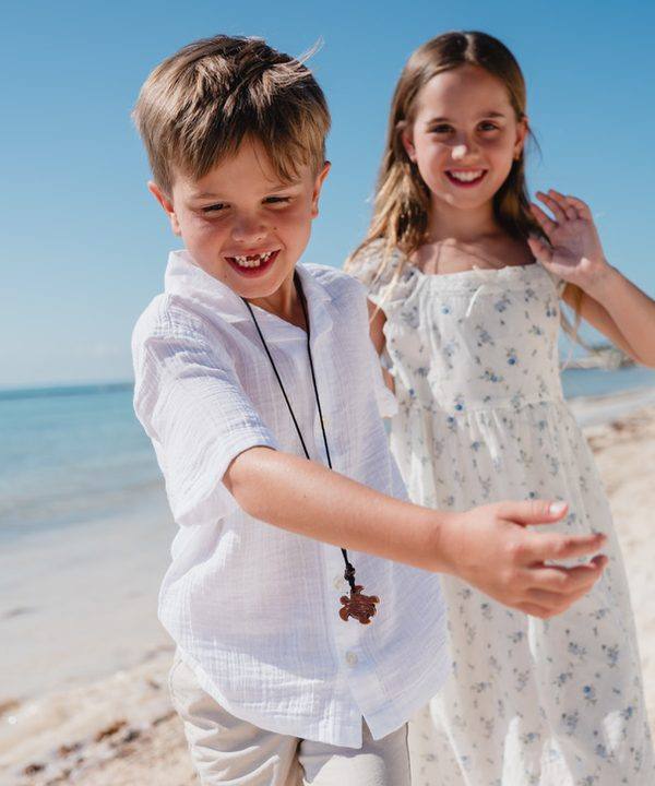 Kristina’s son and daughter laughing on the beach