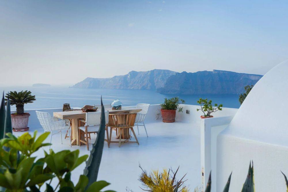 Whitewashed terrace overlooking the sea and caldera in Santorini