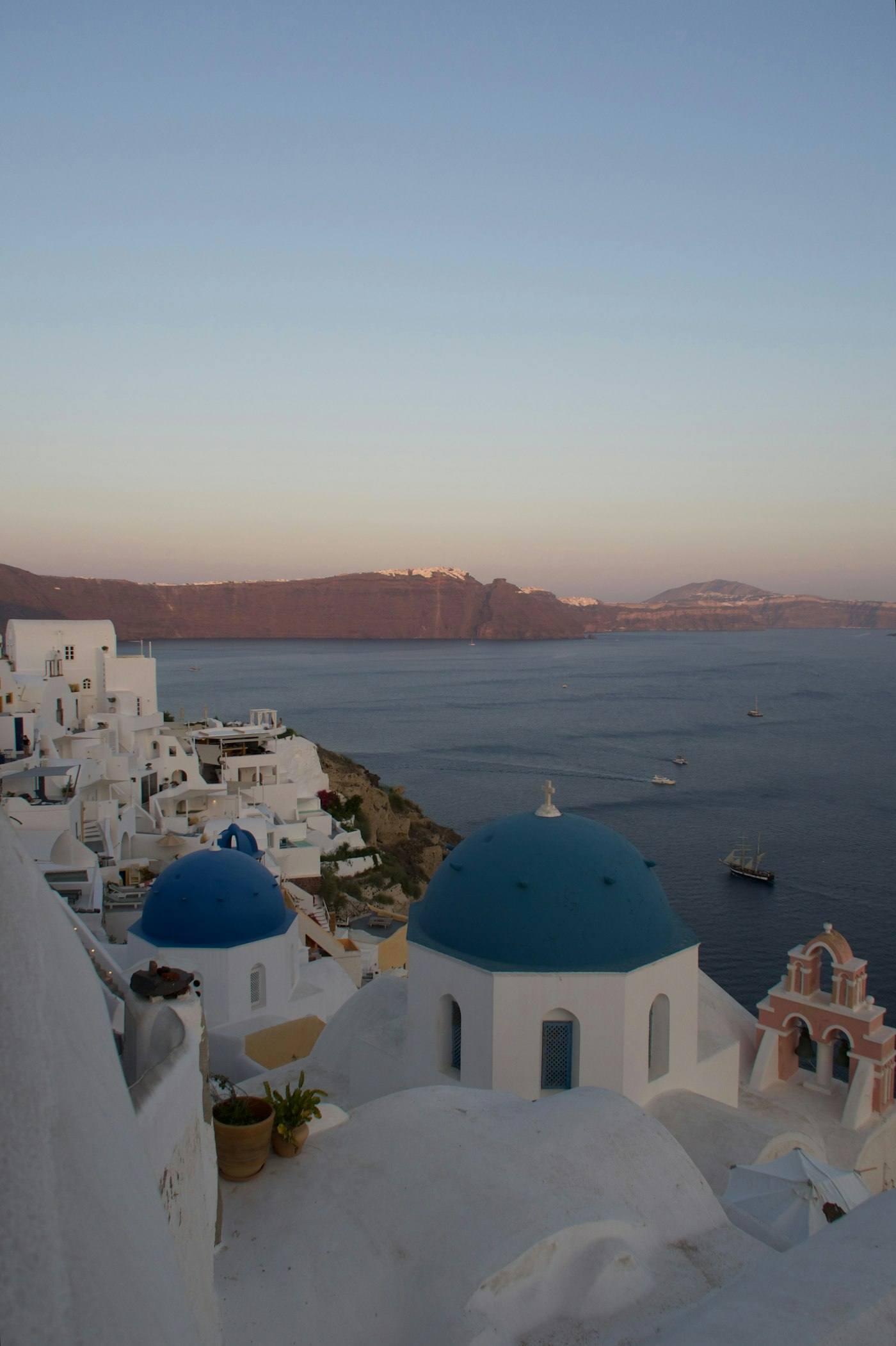 White buildings with blue domes above the sea in Santorini