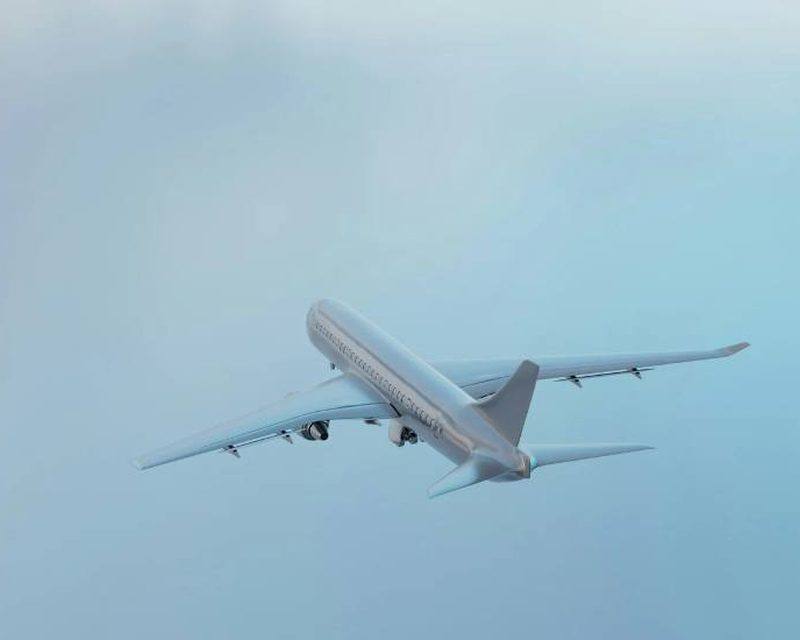 Airplane climbing through a soft blue sky